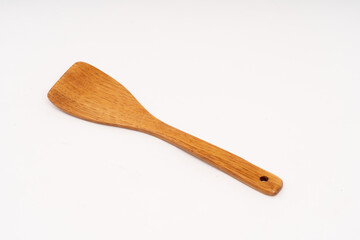 spade of frying pan made from wood on white background selective focus, kitchen flipper