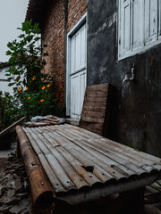 wooden chair in front of old abandoned house