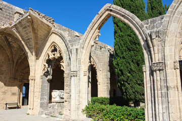 Fototapeta na wymiar Bellapais Abbey, White Abbey, Abbey of the Beautiful world.Arches and the entrance to the refectory, a fragment of the Salamis sarcophagus, used by the monks as a washroom.