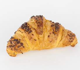 A french croissant filled with hazelnut and covered with chocolate nuggets on white background. French pastry.