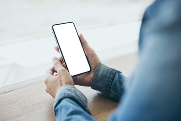 cell phone mockup image blank white screen.woman hand holding texting using mobile on desk at coffee shop.background empty space for advertise.work people contact marketing business,technology
