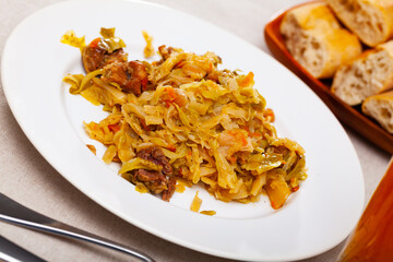 Delicious meat dish – pork with stewed cabbage served on plate