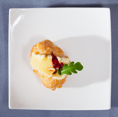 Camembert on top of croissant with pine nuts