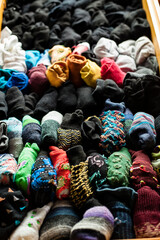 Concept shot of a drawer full of socks arranged by colors. Fashion concept shot background at home, stay at home breakout activities.