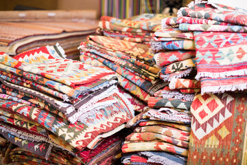 Stack of traditional  colorful carpets in carpet shop