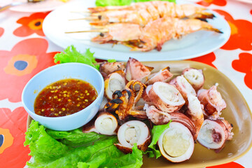 Chopped grill cuttlefish serve with chili-sauce and salad