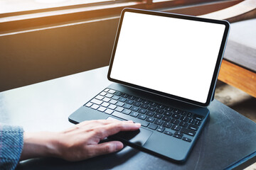 Mockup image of a woman using and touching on tablet touchpad with blank white desktop screen as a computer pc
