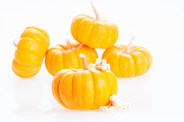Halloween with mini pumpkins and dog bones candy over white background 