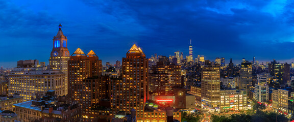 Aerial view of the iconic skyline and skyscrapers of New York Lower Manhattan on a cloudy day after sunset