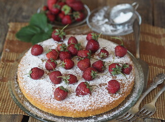 Confectionery background.Round banana biscuit with strawberries on top. Home cooking.
