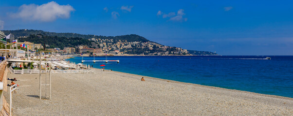 Obraz na płótnie Canvas Pebble beach near famous Promenade des Anglais with the Mediterranean Sea in the background, Nice France