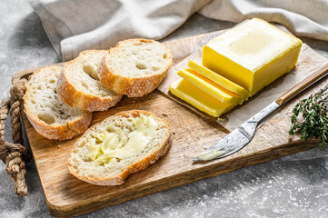 Butter and Baguette  bread for breakfast.  Gray background.Top view