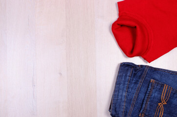 Womanly clothes on wooden board, copy space for text