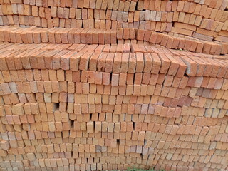 Clay brick stacked  closeup for construction building in construction site.