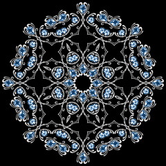 Round decorative pattern on black. Silver jewelry element with gems