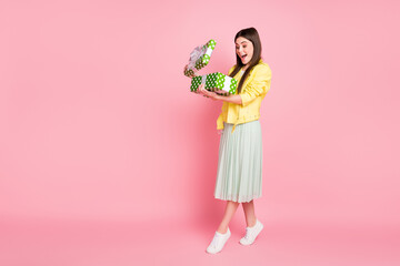 Obraz na płótnie Canvas Full length body size view of her she nice attractive pretty glad cheerful cheery girl opening giftbox from boyfriend having fun isolated on bright vivid shine vibrant yellow color background