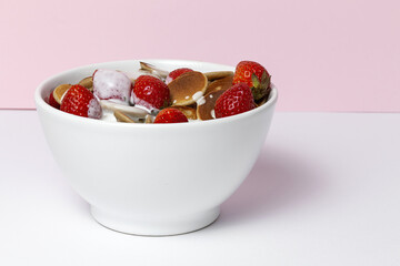 Homemade cereals mini pancake with yogurt, honey and strawberries on colorful background.