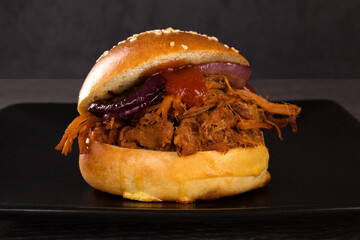 Bbq pulled pork burger on black.