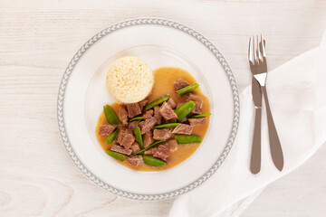 Beef meat stewed with baby peas.