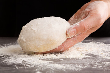 Pizza making. Dough in female hand.