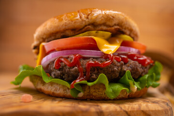 Burger on a wooden background close-up, fast food, macro