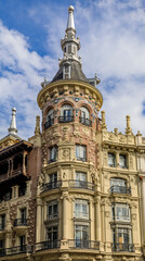 Fototapeta na wymiar Beautiful traditional residential buildings with metal balconies in the streets of the city center in Madrid, Spain