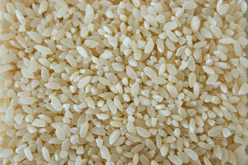 Rice in a glass jar with a spoon, closeup