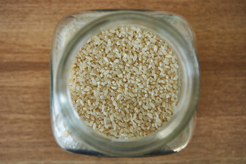 Rice in a glass jar with a spoon, closeup