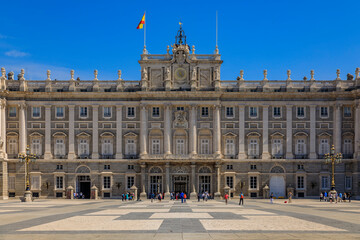Fototapeta na wymiar View of the ornate architecture of the Royal Palace or Palacio Real facade and Plaza de la Armeria in Madrid, Spain