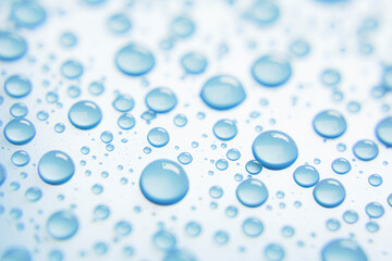 Beautiful big drinking water droplets on the light blue background. 