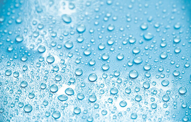 Beautiful big drinking water droplets on the light blue background. 