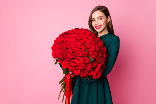 Photo of adorable charming chic lady hold large red long roses bouquet secret admirer boyfriend birthday surprise wear green mini dress isolated pastel pink color background