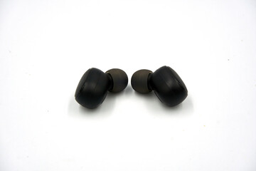 Close up of black wireless earphone over white background