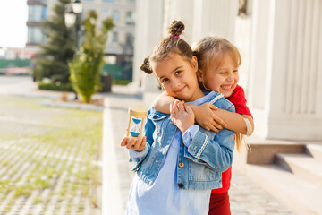 Obraz premium Portrait of happy fashion little girls having fun in the city