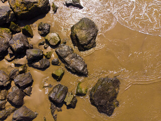 Sand, stones on the beach, top view, vacation and vacation, background for travel agencies