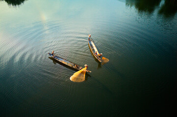HUE CITY, VIETNAM - JUNE 13, 2020: Unidentified fishermen casting fishing nets on Nhu Y river....