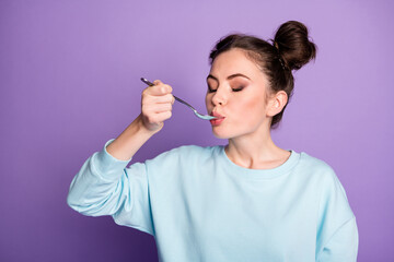 Close-uo portrait of her she nice attractive charming dreamy girl licking spoon eating delicious meal dish dinner isolated on violet purple lilac bright vivid shine vibrant color background