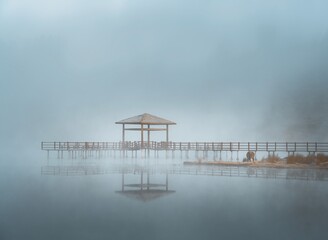 pavilion in the fog near the lake