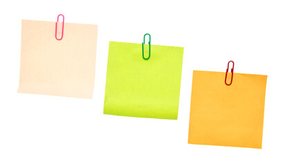 Colored pieces of paper with paper clips on a white background.