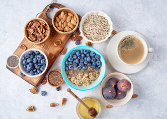 Ingredients for a healthy breakfast, quinoa with blueberry, fig, honey and nuts. Concept vegan and healthy eating. Top view
