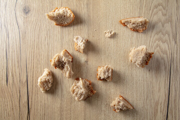 Bread crumbs on a wooden table.