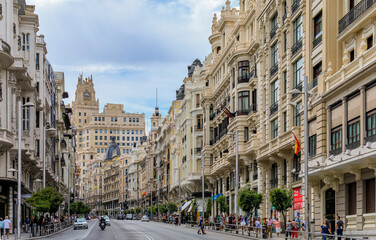 Beautiful buildings on the famous Gran Via shopping street and people walking in the center of the city in Madrid, Spain © SvetlanaSF