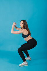 Fototapeta na wymiar sport girl performs workout on blue background