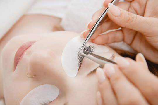 Concept eyelash extension procedure. Macro photo woman with long lashes in beauty salon