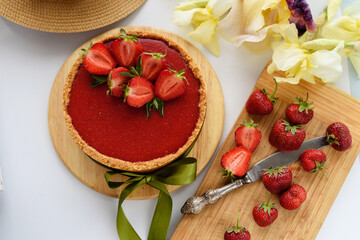 Cold cheesecake with strawberry jelly.