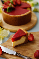 Cold cheesecake with strawberry jelly.