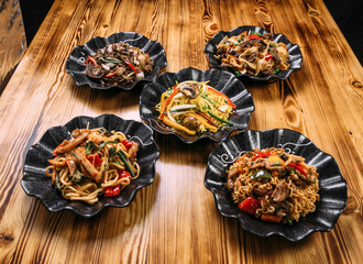 Variety of different noodle dishes asian style wok