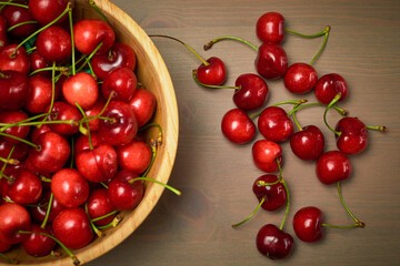 Green spring red cherries on wooden background selective focus cherry