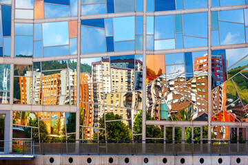 Broken reflection in the modern building in the center of Bilbao, Spain