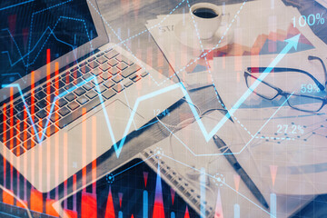Financial market graph hologram and personal computer on background. Double exposure. Concept of forex.